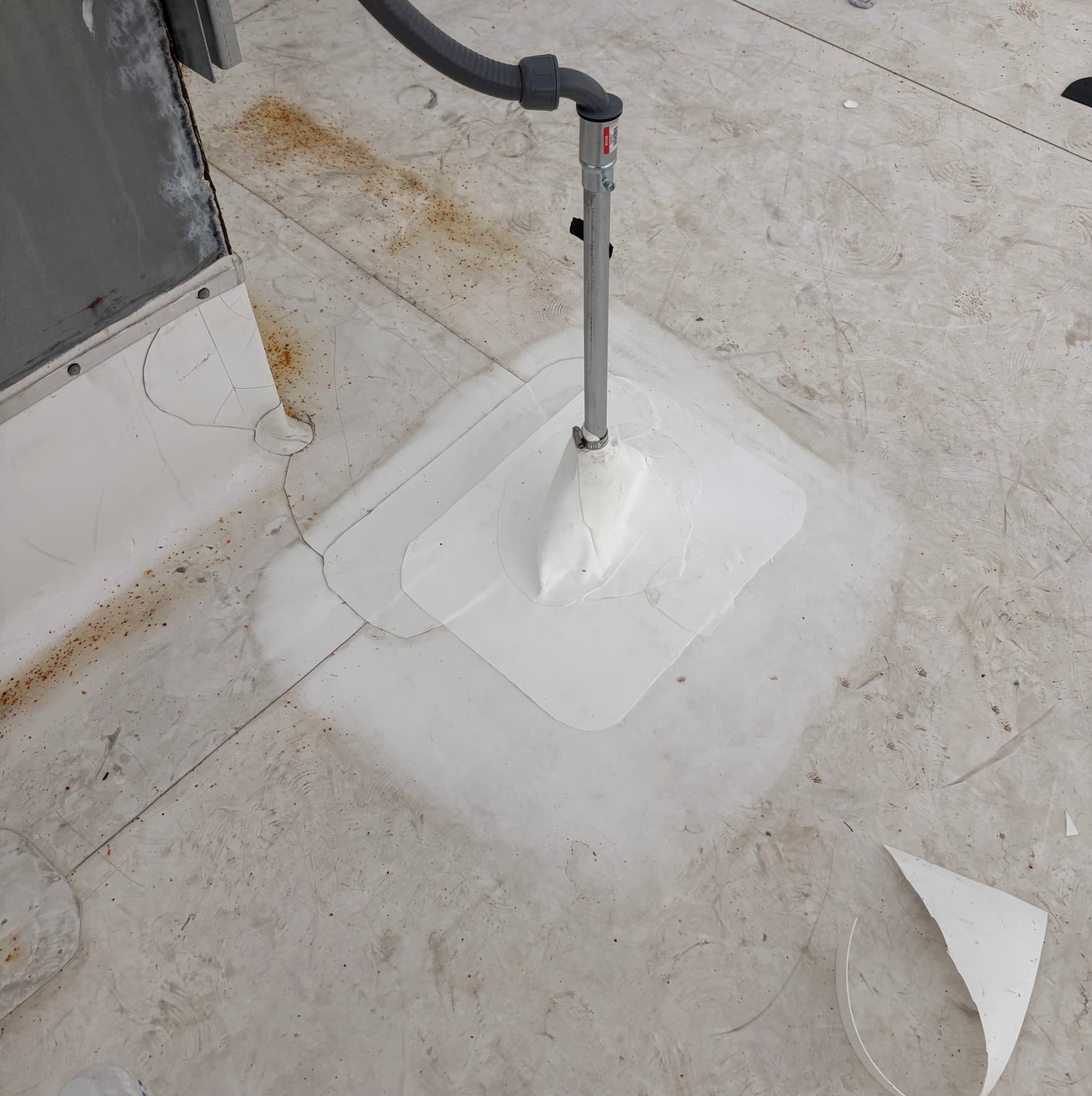 New pipe boot flashing welded into a TPO roof